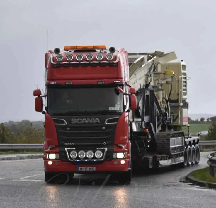 Crusher plant being hauled on a low-loader trailer