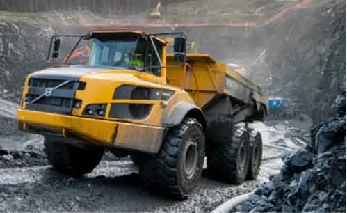 Volvo articulated dump truck operating in a rocky quarry