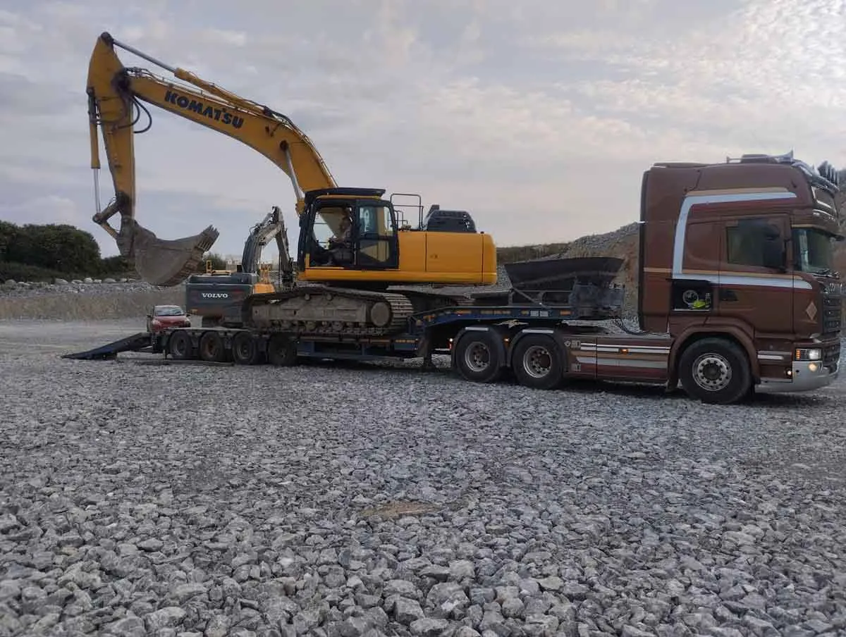 Excavator loaded on a heavy-haulage trailer ready for transport